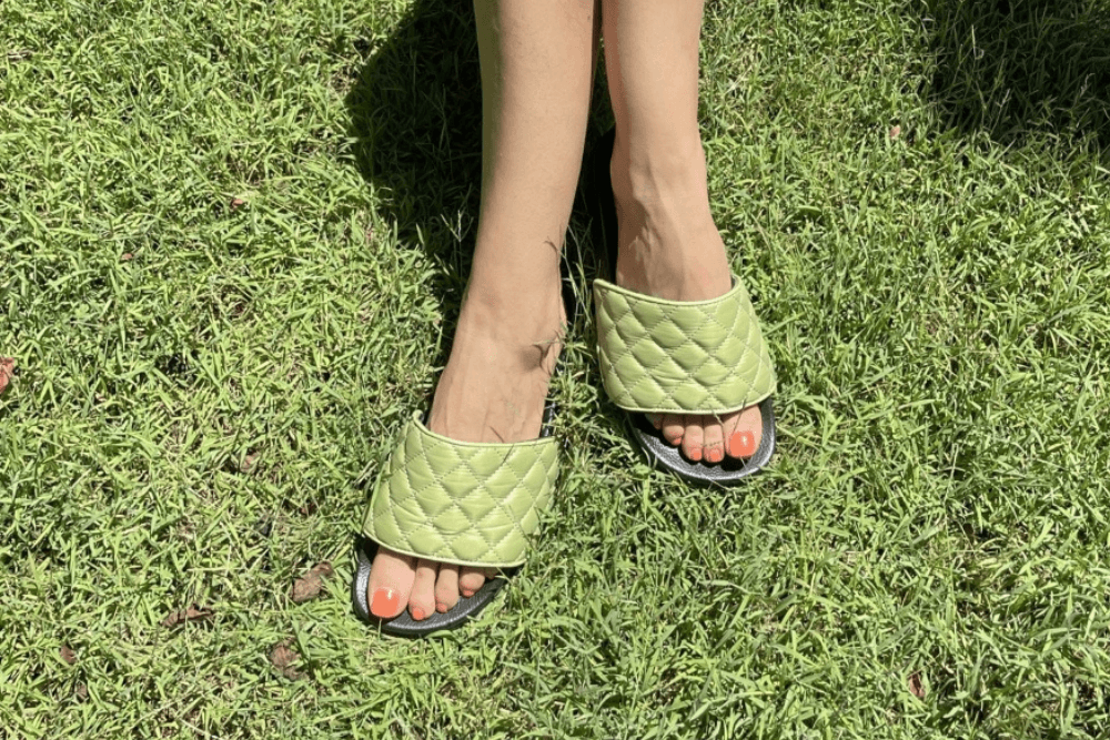 Woman wearing Chimissimi slides with avocado green uppers